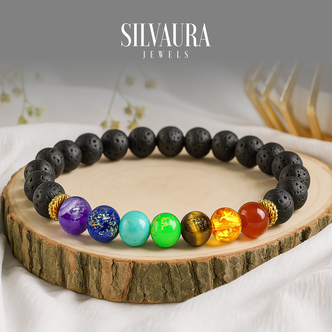 Seven chakra bracelet benefits shown on a colorful beaded bracelet with black lava stones on wooden display