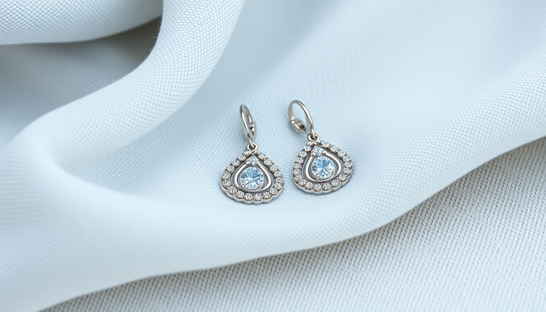 Elegant sterling silver earrings with blue gemstones on white fabric illustrating sterling silver earring care tips for women