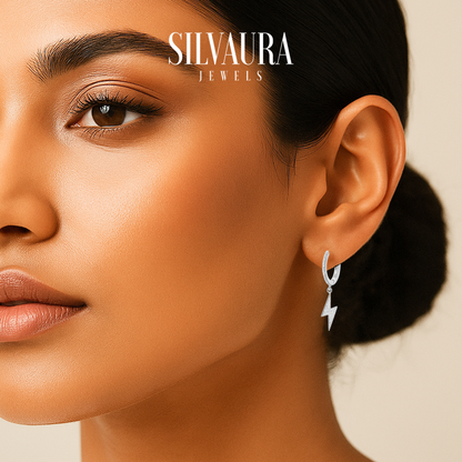 Close up of model wearing sterling silver lightning bolt hoop earrings by SILVAURA JEWELS on warm skin tone